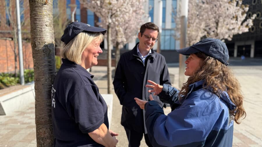 Dan Price talking with two members of the public
