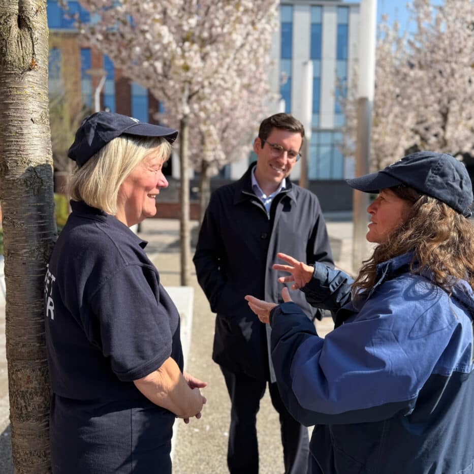 Dan Price talking with two members of the public