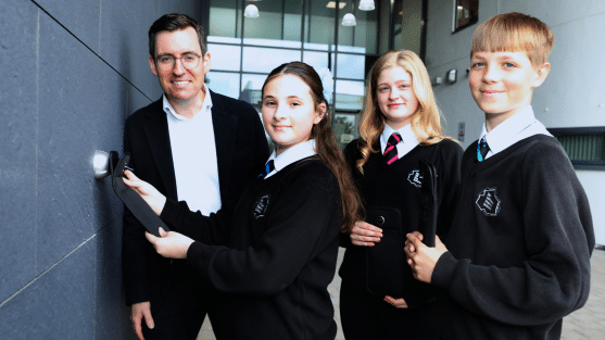 Dan Price, Cheshire Police and Crime Commissioner with pupils from Sir William Stanier School with the lockable phone pouch