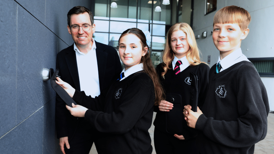 Dan Price, Cheshire Police and Crime Commissioner with pupils from Sir William Stanier School with the lockable phone pouch