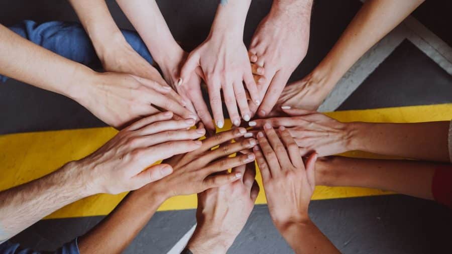 Selection of hands in the centre signifying collaboration