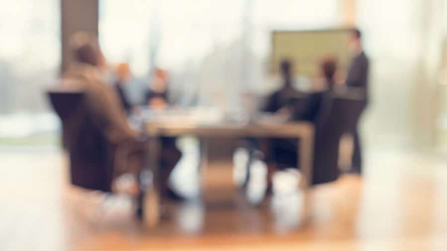 Group of people out of focus scrutinising